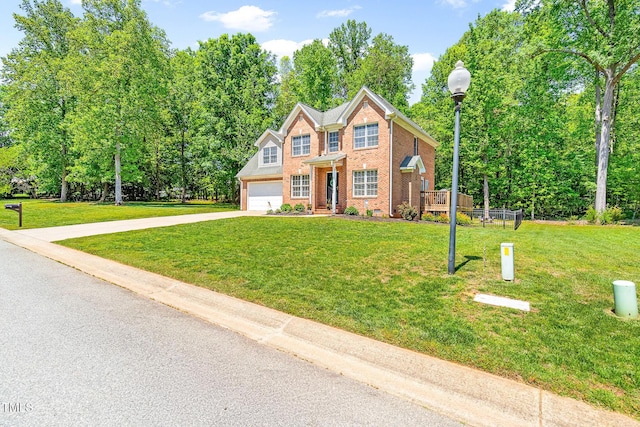 view of front of property featuring concrete driveway, a front lawn, and brick siding