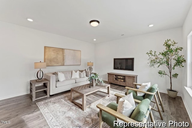 living area with baseboards, recessed lighting, and wood finished floors