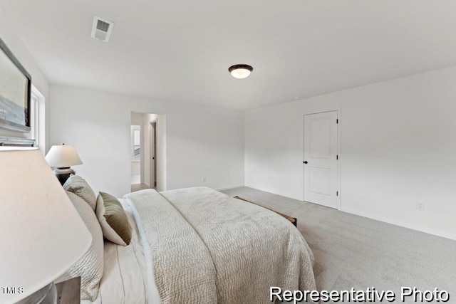 carpeted bedroom with baseboards and visible vents