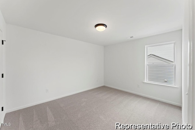 unfurnished room with baseboards and carpet