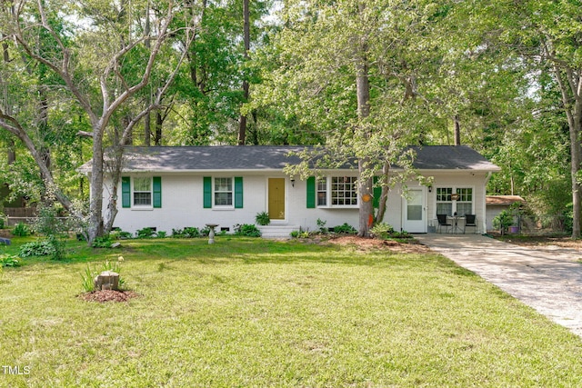 ranch-style home featuring driveway and brick siding