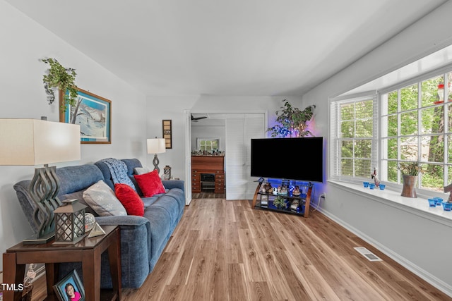 living room featuring wood finished floors and baseboards