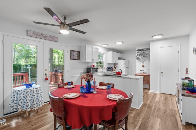 dining space featuring ceiling fan, french doors, and light wood-style floors