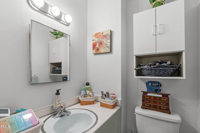 half bath featuring toilet and vanity