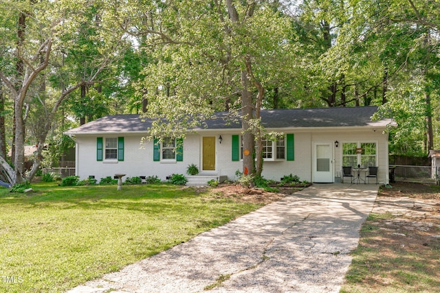 ranch-style home featuring driveway and brick siding