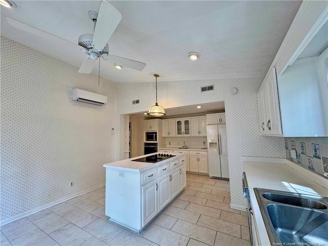 161 Lakeview Dr, Southern Pines, NC 28387 - kitchen with wallpapered walls, a center island, light countertops, a wall unit AC, and black appliances