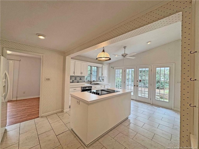 161 Lakeview Dr, Southern Pines, NC 28387 - kitchen with wallpapered walls, light countertops, white cabinets, french doors, and black appliances