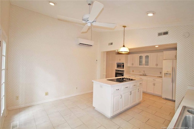 161 Lakeview Dr, Southern Pines, NC 28387 - kitchen with visible vents, wallpapered walls, a wall mounted AC, a sink, and black appliances