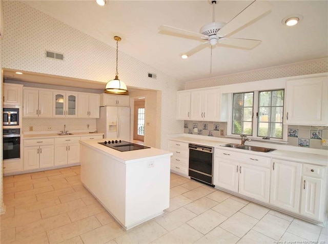 161 Lakeview Dr, Southern Pines, NC 28387 - kitchen featuring visible vents, a sink, black appliances, and wallpapered walls