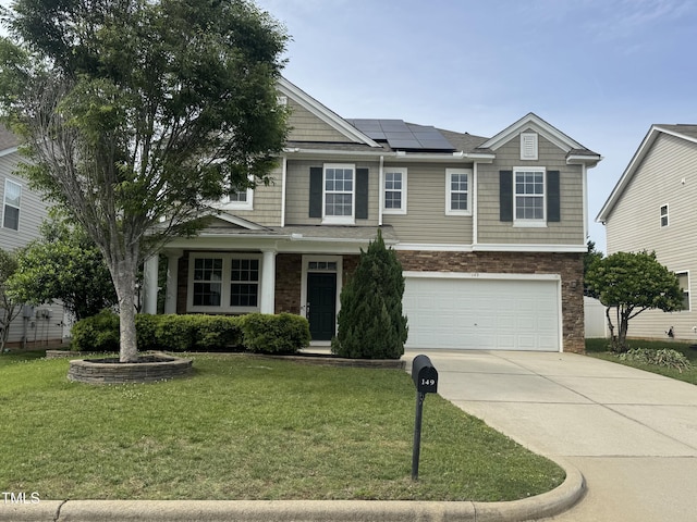 view of front facade with solar panels, a garage, concrete driveway, a front lawn, and stone siding