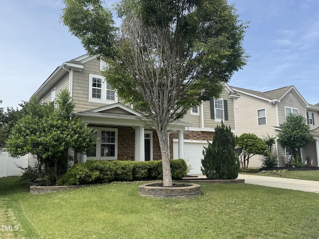 view of front of house featuring a garage, a front yard, and driveway