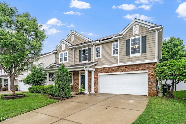 149 Cinder Cross Way, Garner, NC 27529 - view of front of home with driveway, an attached garage, a front yard, and roof mounted solar panels