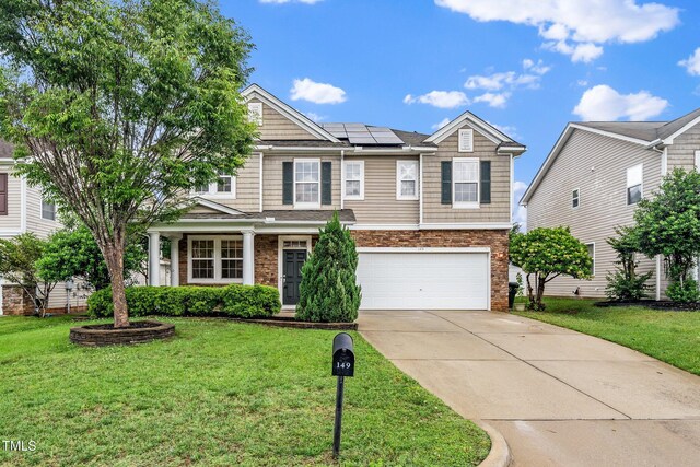 149 Cinder Cross Way, Garner, NC 27529 - view of front of property featuring an attached garage, driveway, roof mounted solar panels, and a front lawn