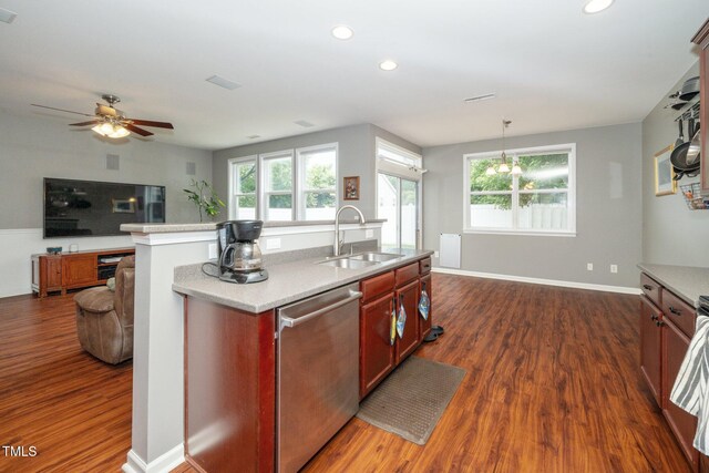 149 Cinder Cross Way, Garner, NC 27529 - kitchen featuring a sink, stainless steel dishwasher, dark wood-type flooring, open floor plan, and healthy amount of natural light