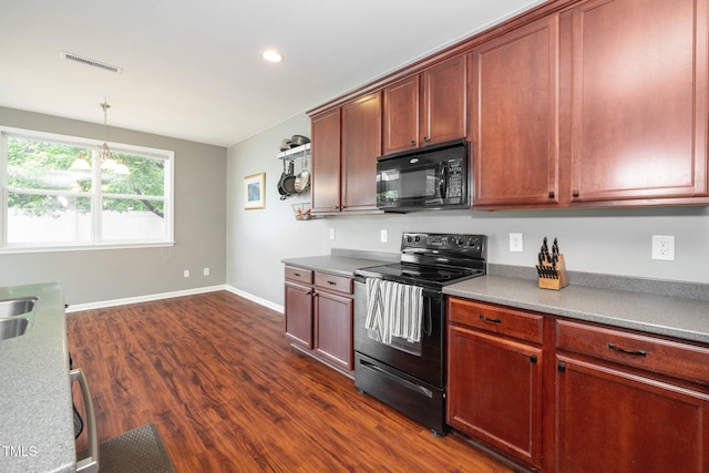 149 Cinder Cross Way, Garner, NC 27529 - kitchen with black appliances, dark wood finished floors, baseboards, recessed lighting, and decorative light fixtures