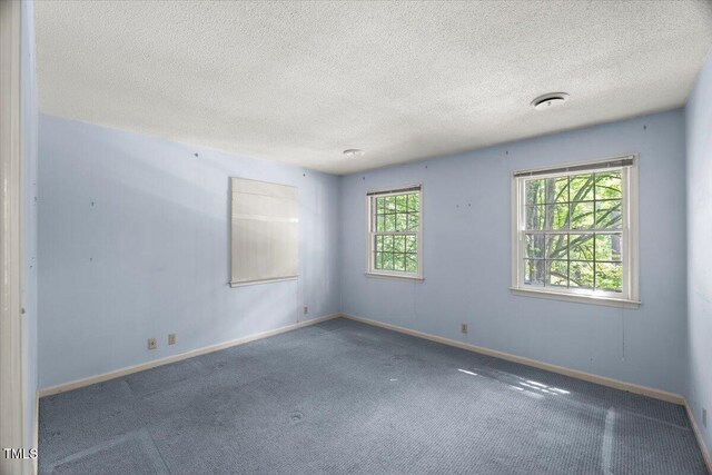 3025 Wycliff Rd, Raleigh, NC 27607 - spare room with baseboards, carpet, and a textured ceiling