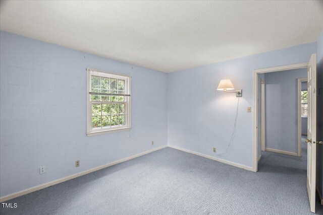 3025 Wycliff Rd, Raleigh, NC 27607 - spare room with baseboards, carpet, and a textured ceiling