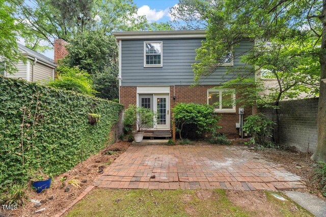 3025 Wycliff Rd, Raleigh, NC 27607 - rear view of property featuring brick siding and a patio area