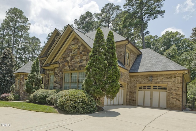 5901 Charleycote Dr, Raleigh, NC 27614 - view of front of property with an attached garage, concrete driveway, stone siding, and brick siding