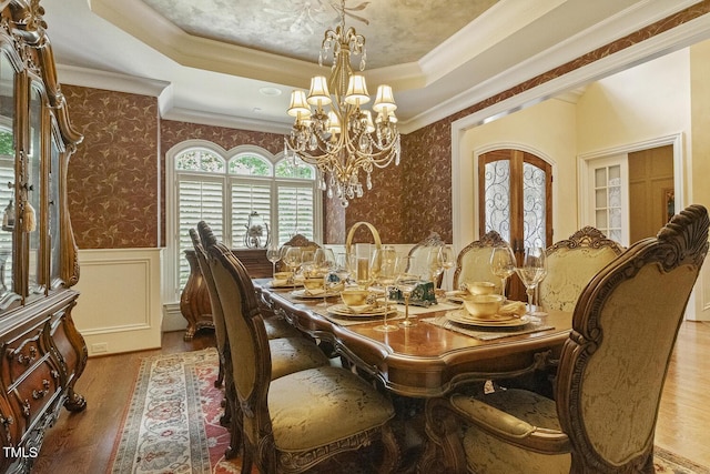 5901 Charleycote Dr, Raleigh, NC 27614 - dining area with crown molding, a raised ceiling, wainscoting, and a chandelier