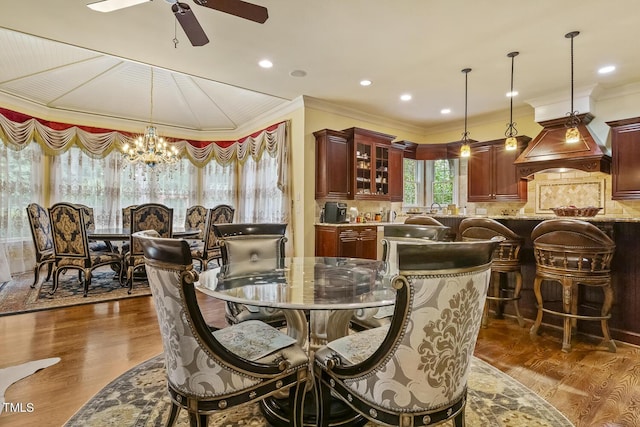 5901 Charleycote Dr, Raleigh, NC 27614 - dining area with dark wood-style flooring, recessed lighting, ornamental molding, and ceiling fan with notable chandelier