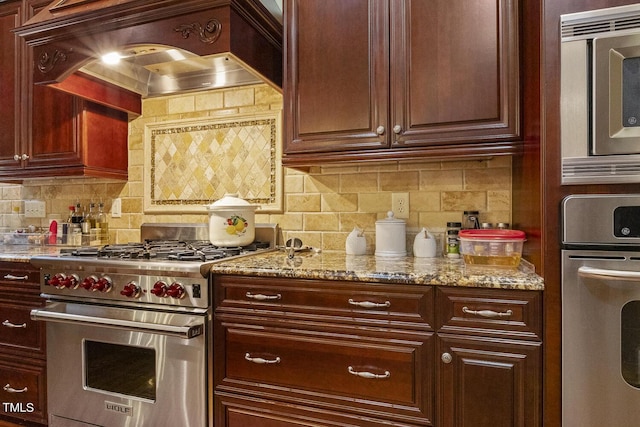 5901 Charleycote Dr, Raleigh, NC 27614 - kitchen featuring appliances with stainless steel finishes, tasteful backsplash, light stone countertops, and custom exhaust hood