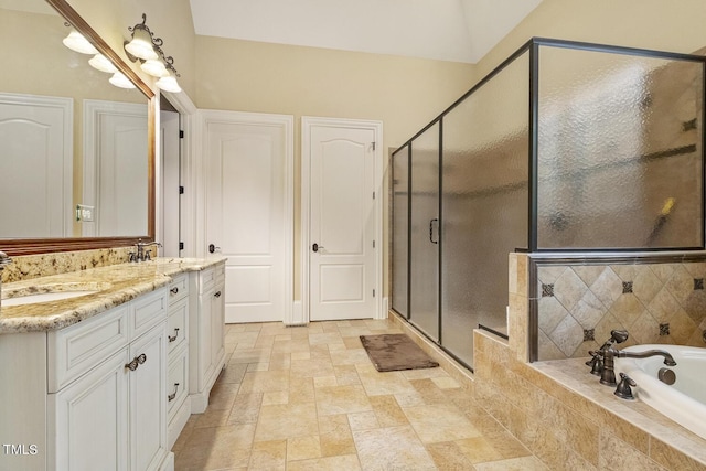 5901 Charleycote Dr, Raleigh, NC 27614 - full bathroom featuring a sink, double vanity, stone tile floors, a bath, and a stall shower
