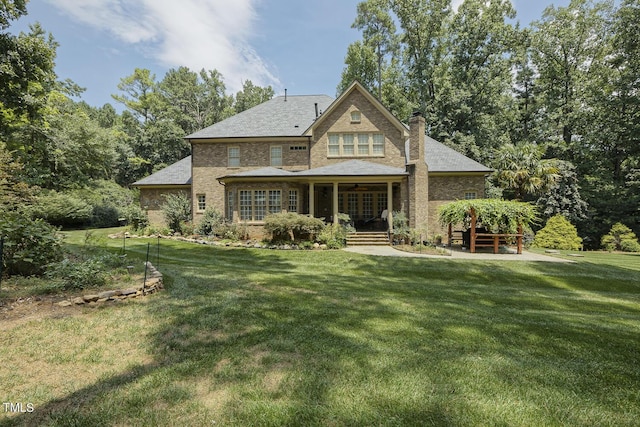 5901 Charleycote Dr, Raleigh, NC 27614 - rear view of property featuring a lawn, brick siding, ceiling fan, and a chimney