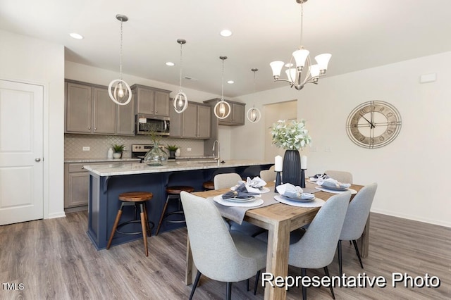 187 Curling Creek Dr Unit 298P, Clayton, NC 27527 - dining area featuring an inviting chandelier, recessed lighting, baseboards, and wood finished floors