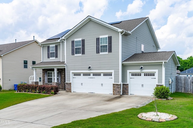 1104 Arden Trace Ct, Fuquay Varina, NC 27526 - view of front of property featuring concrete driveway, solar panels, stone siding, and roof with shingles