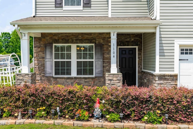 1104 Arden Trace Ct, Fuquay Varina, NC 27526 - entrance to property with stone siding, a porch, and roof with shingles