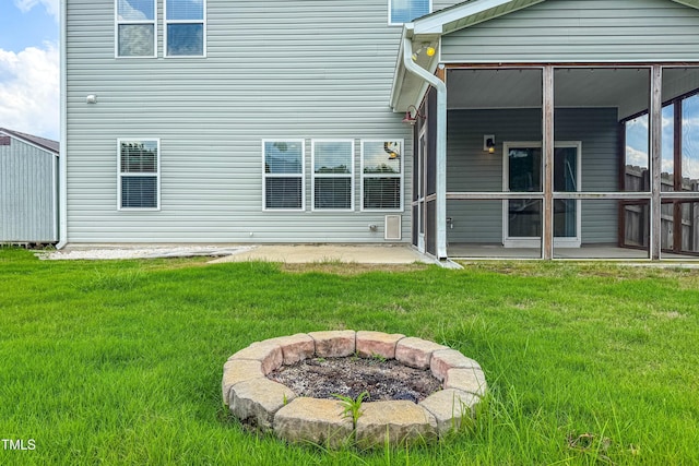 1104 Arden Trace Ct, Fuquay Varina, NC 27526 - back of house featuring an outdoor fire pit, a patio, a yard, and a sunroom