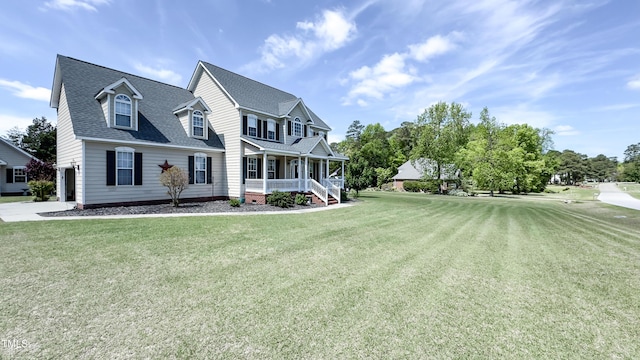 view of front of property with covered porch, a garage, a shingled roof, and a front lawn
