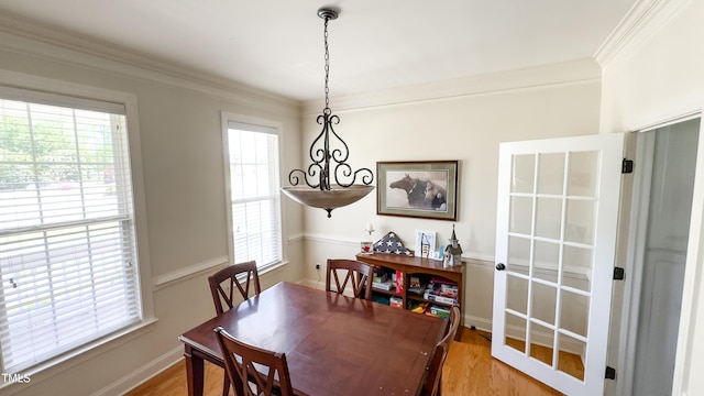 dining space with plenty of natural light and light wood-style flooring