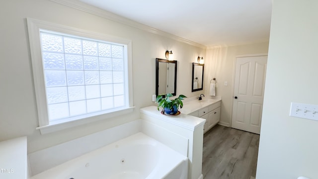full bath with ornamental molding, a tub with jets, wood finished floors, and vanity