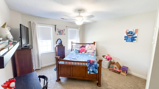bedroom featuring baseboards, light colored carpet, ceiling fan, and visible vents