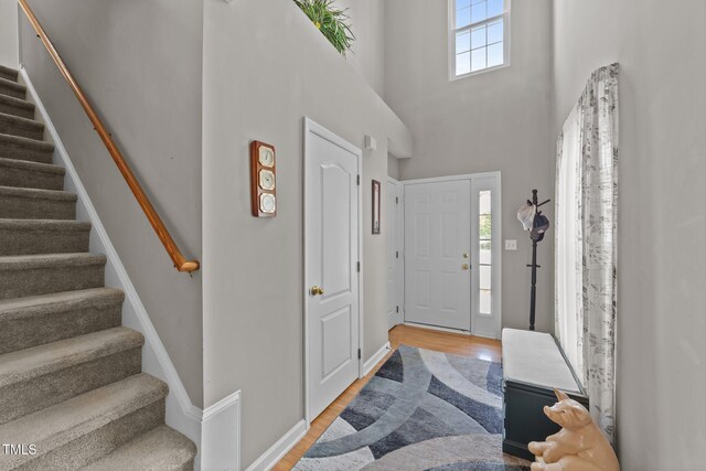 228 Honeywell Way, Fuquay Varina, NC 27526 - foyer entrance featuring plenty of natural light, a towering ceiling, stairway, and light wood-type flooring