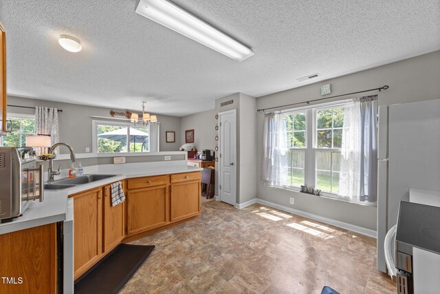 228 Honeywell Way, Fuquay Varina, NC 27526 - kitchen featuring a sink, a textured ceiling, a notable chandelier, and light countertops