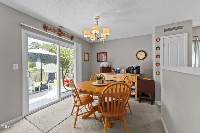 228 Honeywell Way, Fuquay Varina, NC 27526 - dining area with a textured ceiling, visible vents, baseboards, an inviting chandelier, and carpet