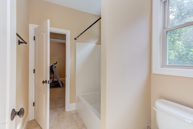bathroom featuring plenty of natural light, toilet, shower / tub combination, and tile patterned floors