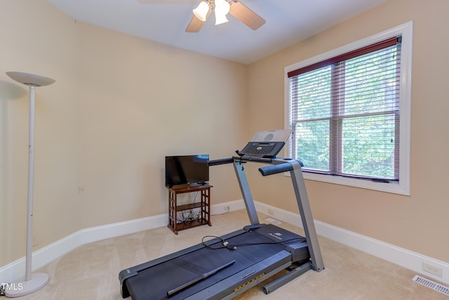exercise room with ceiling fan, carpet flooring, and baseboards