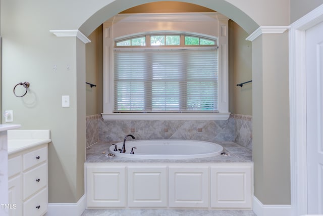 full bathroom with a garden tub and vanity