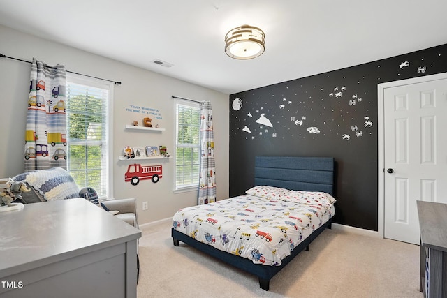 bedroom with light carpet and baseboards