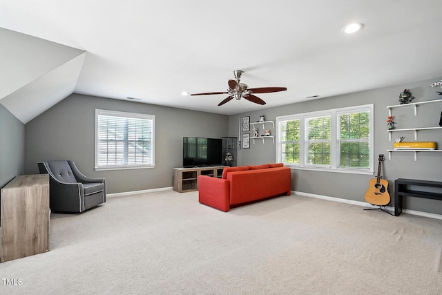 living room featuring carpet, plenty of natural light, a ceiling fan, baseboards, and vaulted ceiling