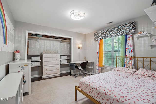 bedroom featuring an office area and carpet floors