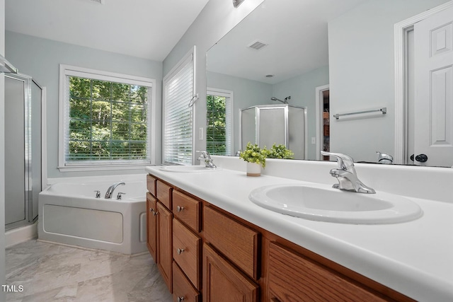 bathroom with a shower stall, a garden tub, double vanity, and marble finish flooring