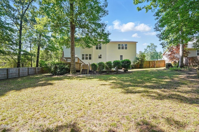 rear view of property featuring stairway and a deck