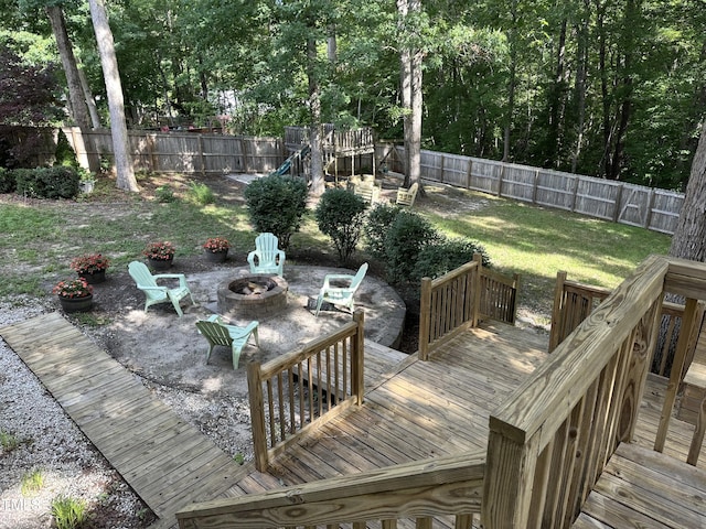 deck featuring a fire pit, a playground, and a patio area