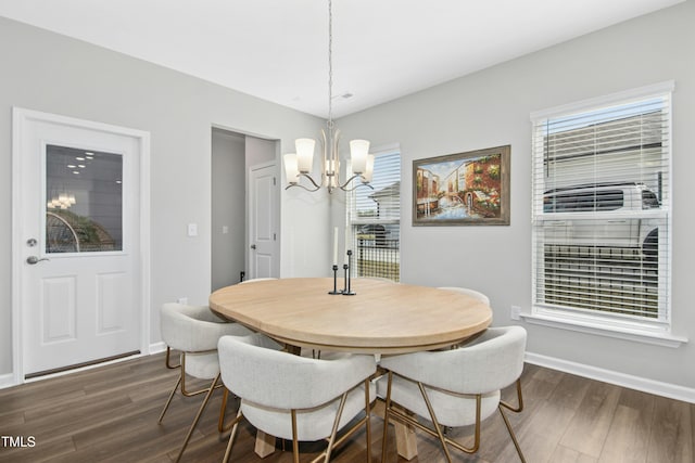5009 Megara Run, Raleigh, NC 27603 - dining area featuring a chandelier, dark wood-type flooring, and baseboards
