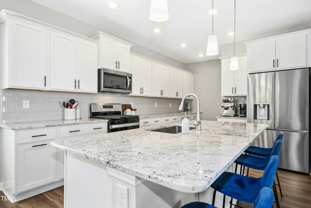 5009 Megara Run, Raleigh, NC 27603 - kitchen featuring stainless steel appliances, a sink, a kitchen island with sink, dark wood-type flooring, and recessed lighting